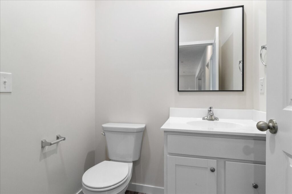 Modern bathroom interior featuring a sleek vanity and minimalist design elements.