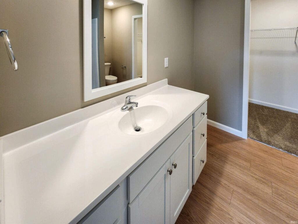 Modern bathroom sink with a spacious countertop and stylish mirror reflection.