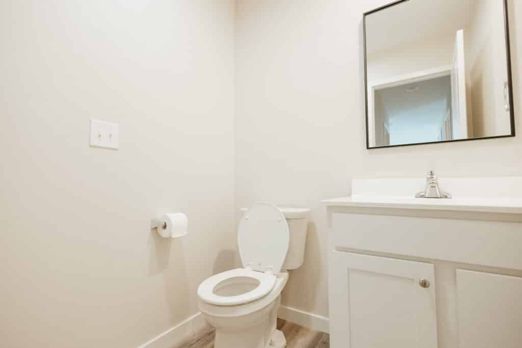 Simple bathroom with a toilet and modern fixtures for easy accessibility.