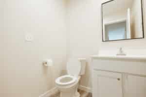 Simple bathroom with a toilet and modern fixtures for easy accessibility.