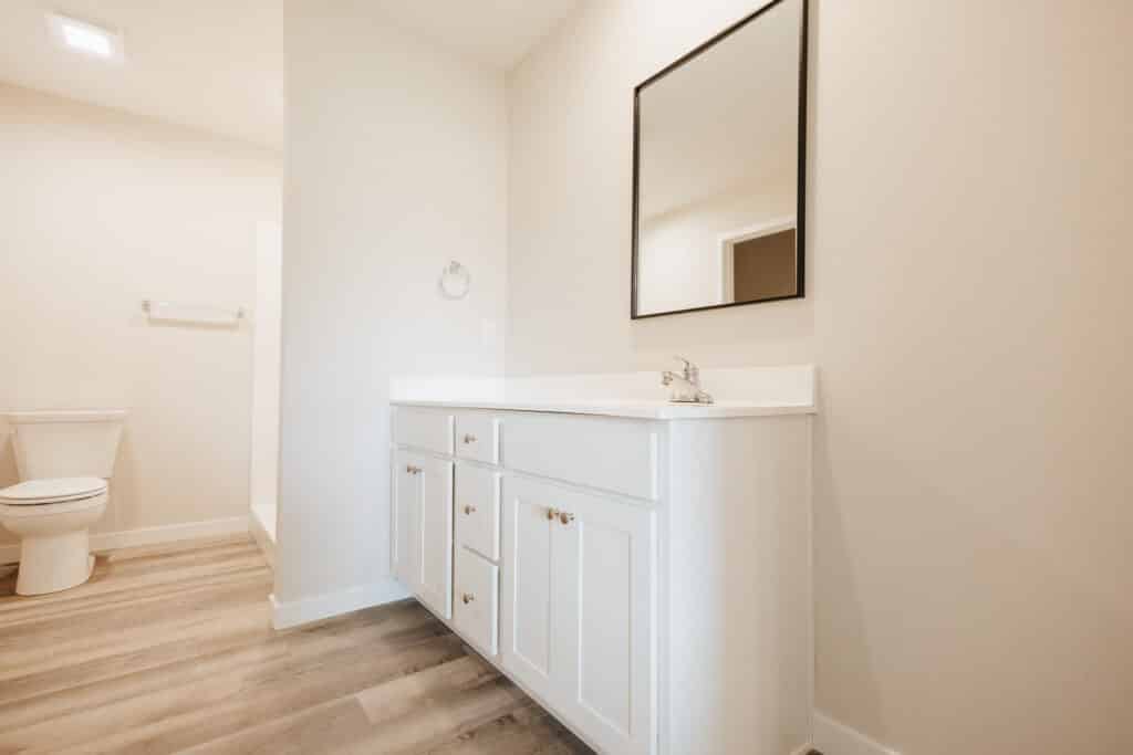 Modern white bathroom vanity with sleek design and spacious storage.