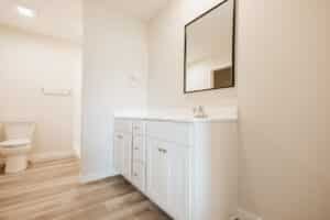 Modern white bathroom vanity with sleek design and spacious storage.
