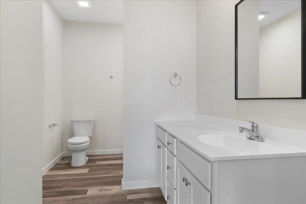 Modern, clean bathroom with stylish fixtures, vanity, and spacious layout.