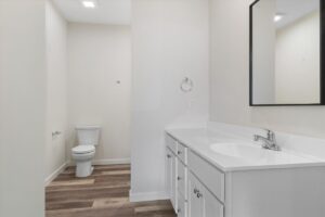 Modern, clean bathroom with stylish fixtures, vanity, and spacious layout.