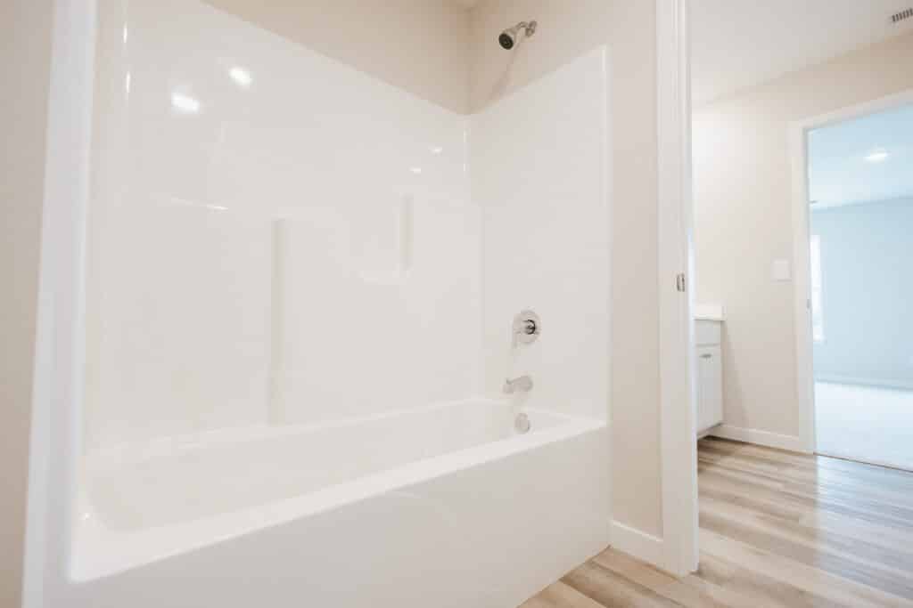 Modern bathtub installation guide featuring a sleek design and efficient plumbing setup.