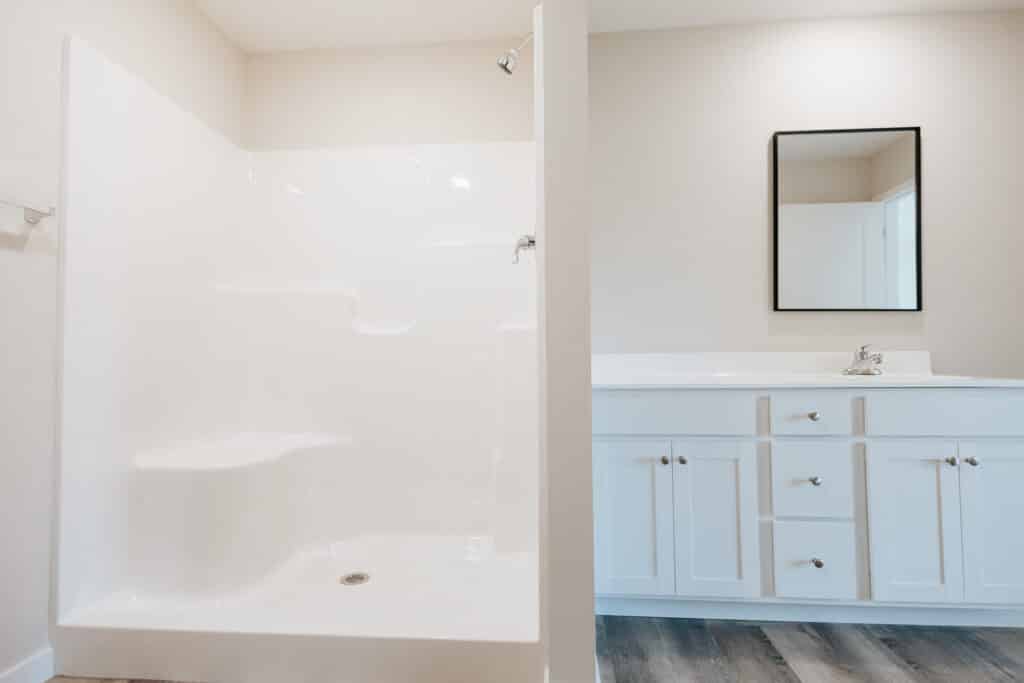 Modern bathroom featuring a clean shower area and stylish vanity cabinet.