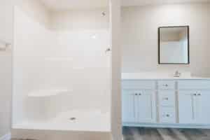 Modern bathroom featuring a clean shower area and stylish vanity cabinet.