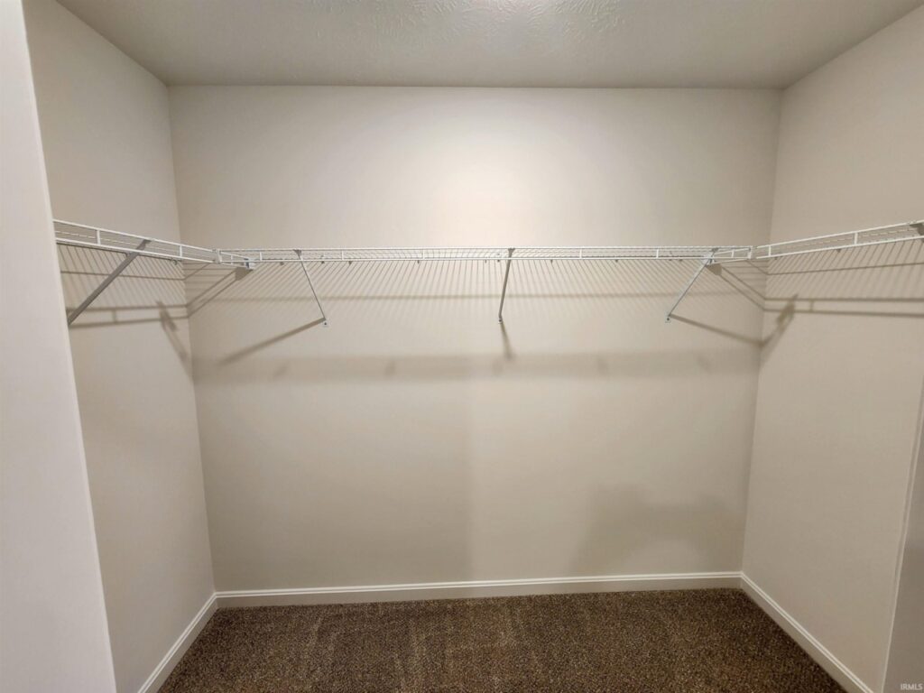 Spacious empty closet storage with wire shelving for organization and easy access.