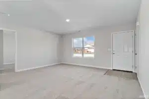 Spacious empty living room with natural light and neutral colors, ideal for customization.