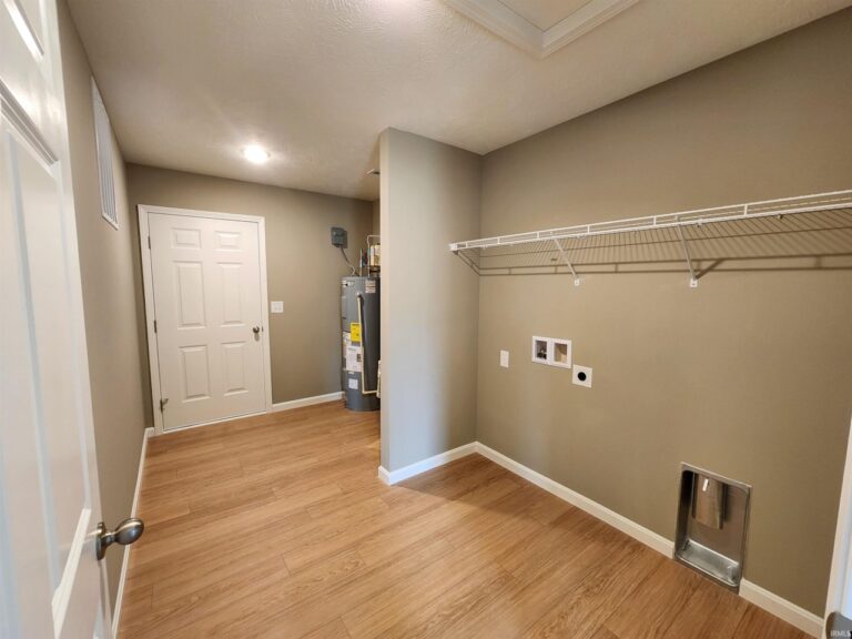 Bright and functional laundry room with essential appliances and organized shelving.