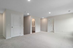 Bright, spacious room with doors and neutral decor, perfect for modern living.