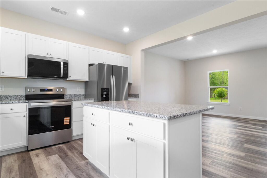 Bright modern kitchen with stainless steel appliances and granite countertops.