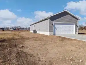 Stylish new home exterior with garage and clear blue skies.