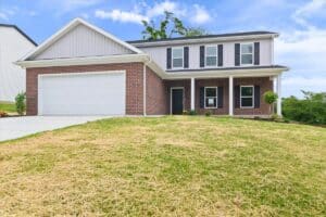 Stylish new home exterior with brick facade and landscaped yard.