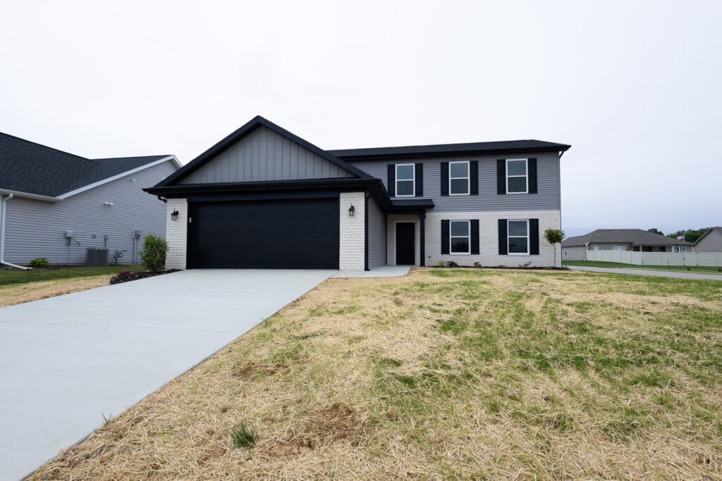 Modern two-story home exterior with a driveway and landscaping features.