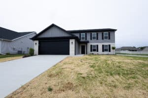 Modern two-story home exterior with a driveway and landscaping features.
