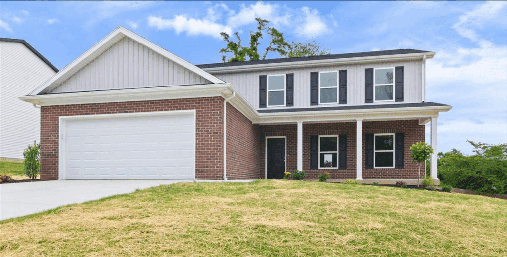 Newly built modern home with brick facade and landscaped front yard.