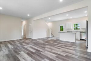 Bright and spacious living room with modern layout and stylish hardwood flooring.