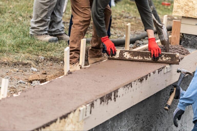 Pouring concrete with expert techniques for a smooth and even finish.