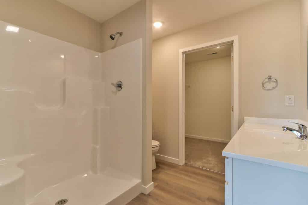 Modern bathroom overview featuring shower, sink, and clean design elements.