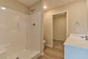 Modern bathroom overview featuring shower, sink, and clean design elements.