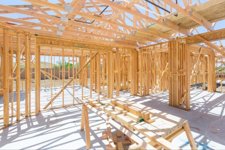 Progress on a new construction project showcasing wooden framing and structures.
