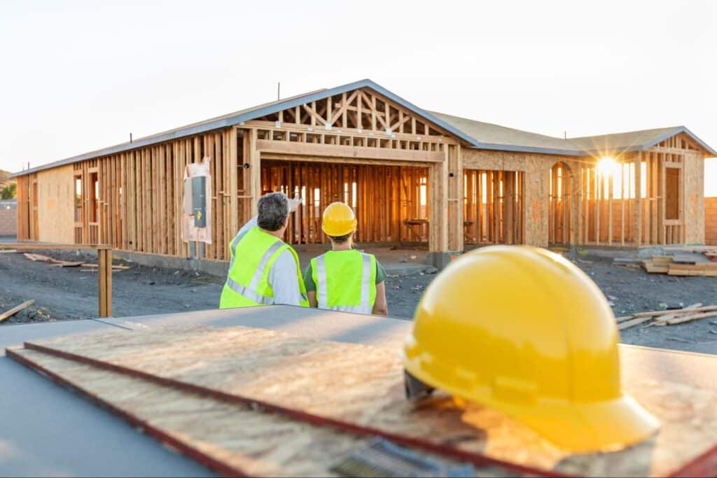 Construction professionals assessing progress at a new home building site.
