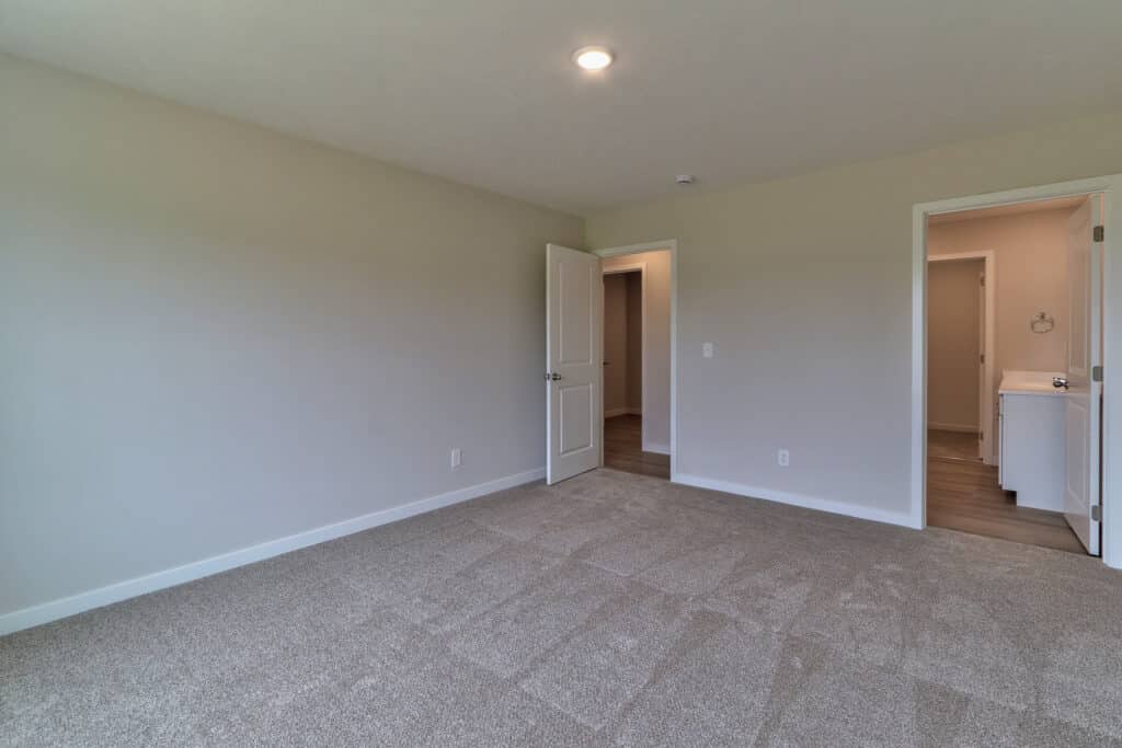 Spacious empty room with doors, perfect for decorating and creating a cozy space.