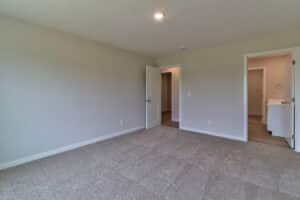 Spacious empty room with doors, perfect for decorating and creating a cozy space.