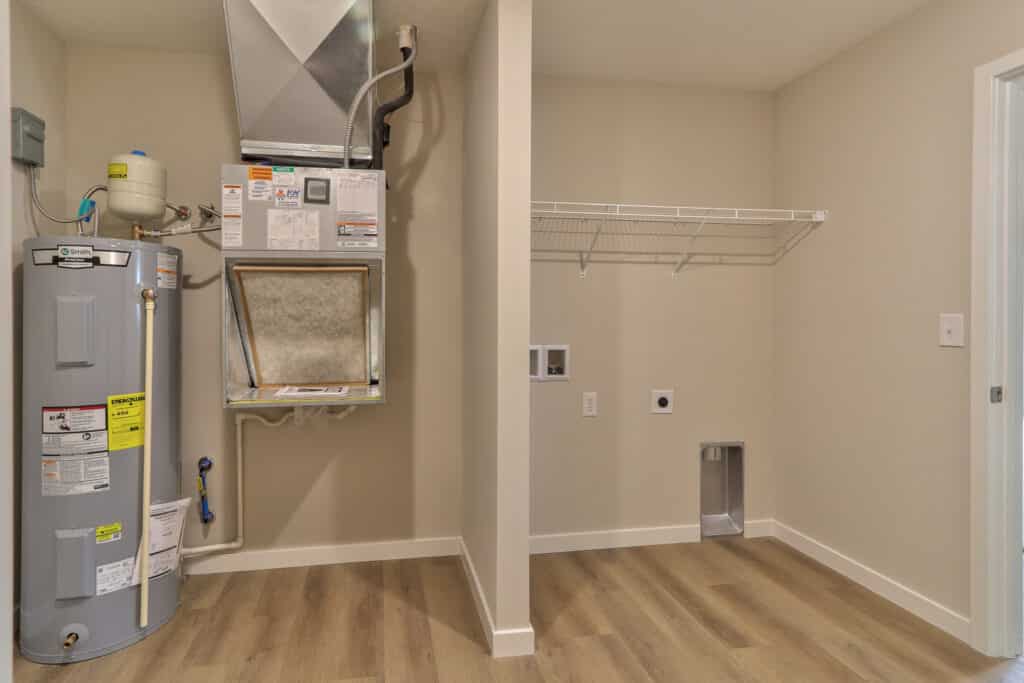 Modern laundry room featuring efficient washer, dryer connections, and storage options.