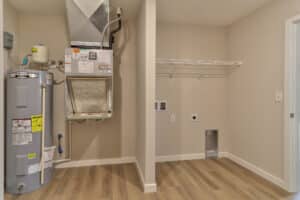 Modern laundry room featuring efficient washer, dryer connections, and storage options.