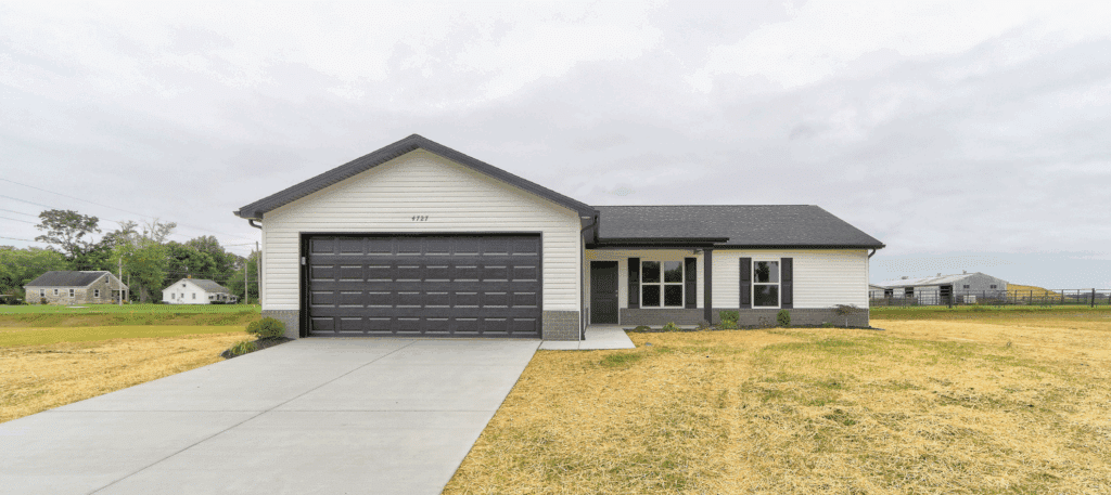 Modern new home with a stylish garage and spacious front yard for sale.