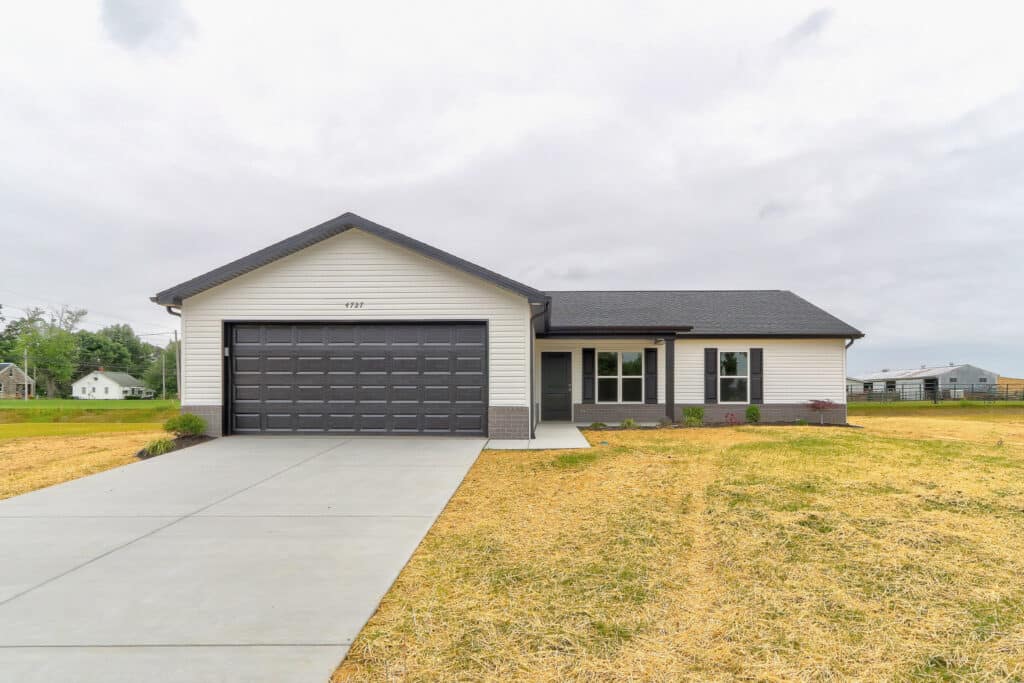 Modern front view of a beautiful new home with a spacious garage.