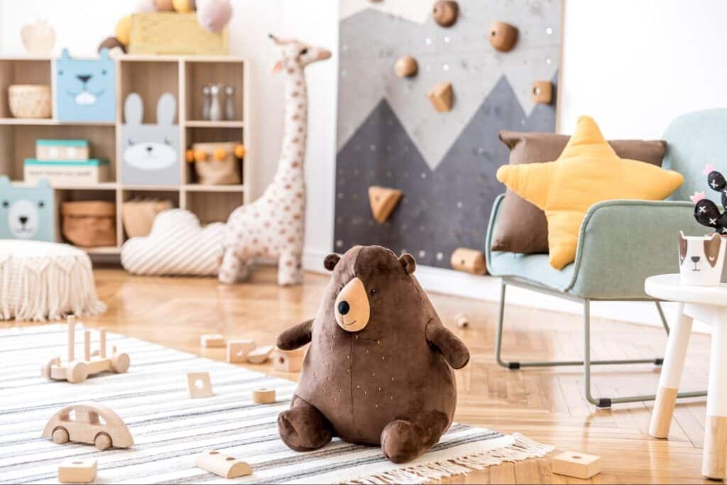 Cozy bear-themed playroom for kids with toys and playful decor.
