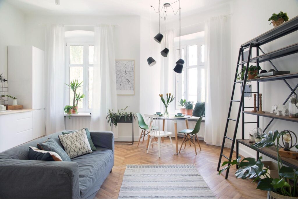Modern living room design featuring plants and stylish decor for a fresh ambiance.