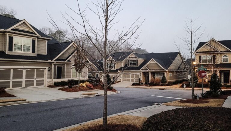 Peaceful neighborhood streets glowing in morning light, showcasing charming homes and serene scenery.