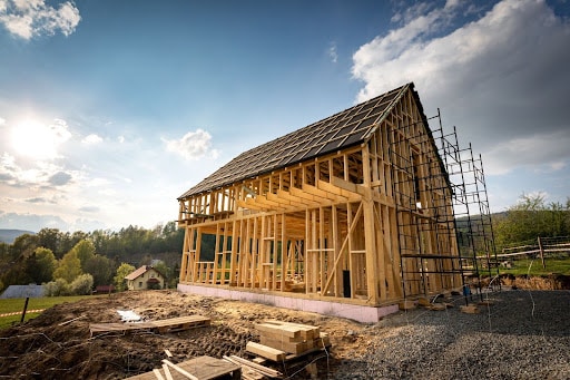 Home construction in progress on your lot, showcasing framing and scaffolding.