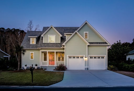 Modern home exterior at dusk, perfect for new homeowners maintenance tips.