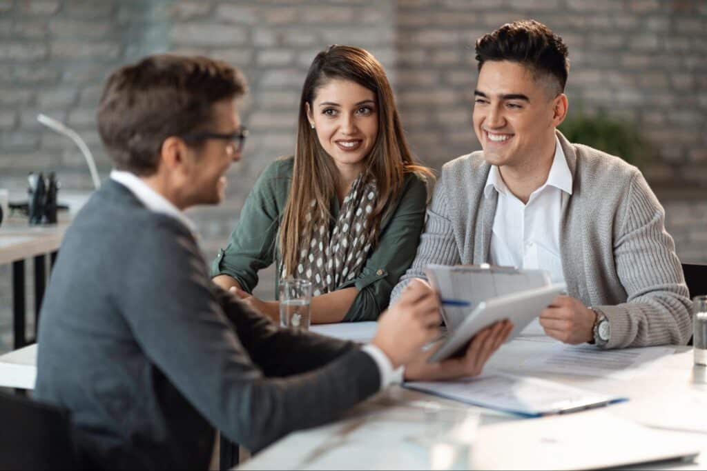 Young professionals engaged in a friendly business discussion at a stylish office.