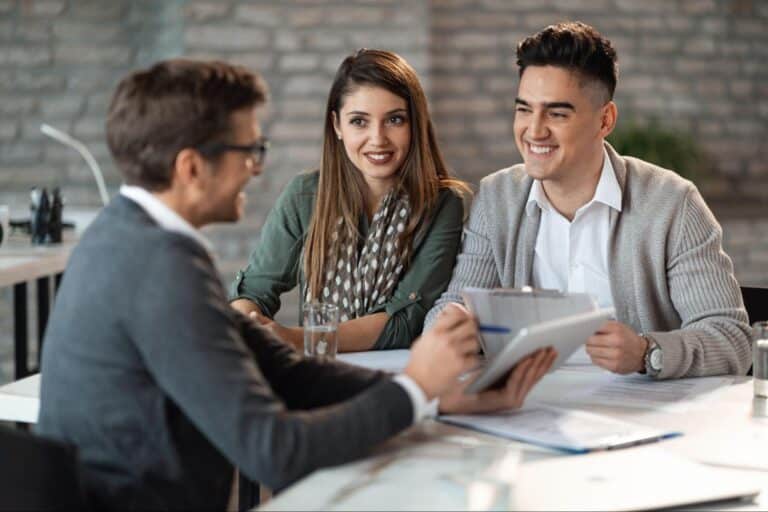 Young professionals engaged in a friendly business discussion at a stylish office.