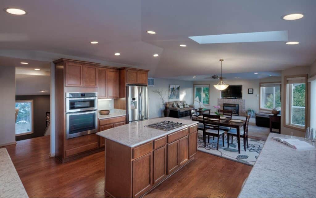 Spacious modern kitchen with wooden cabinets and an inviting dining area conveying Choosing a Floor Plan concept