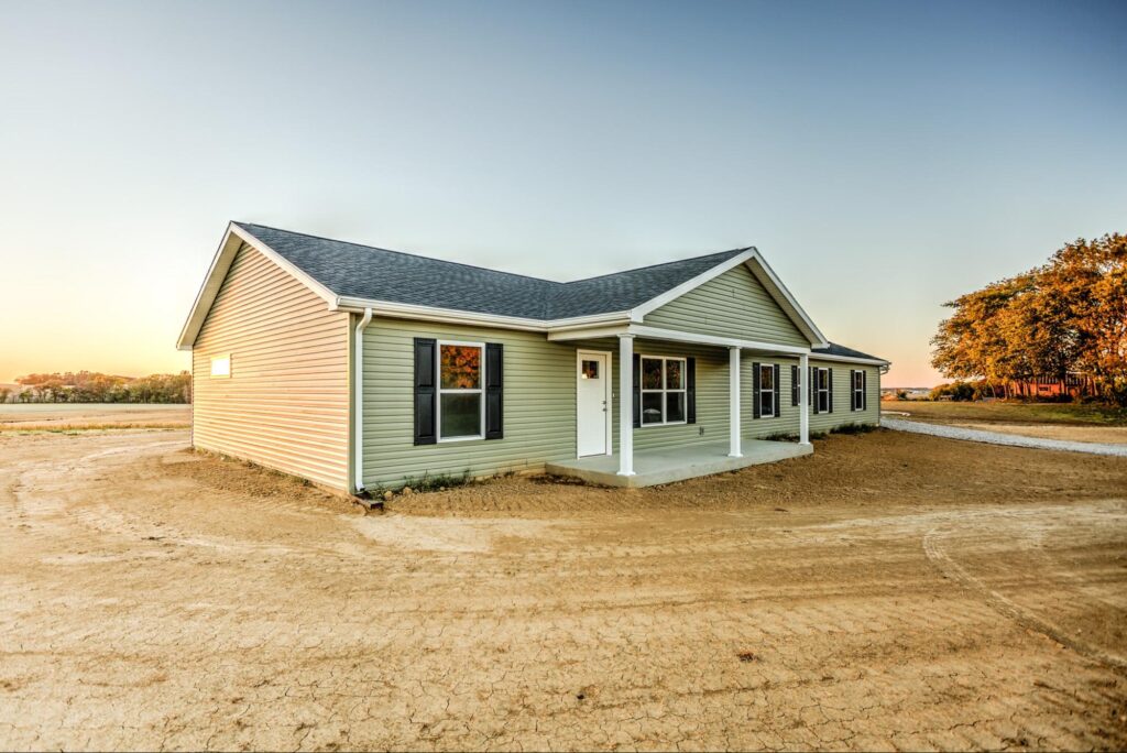 Modern home exterior with a spacious yard and sunset view, perfect for new beginnings.