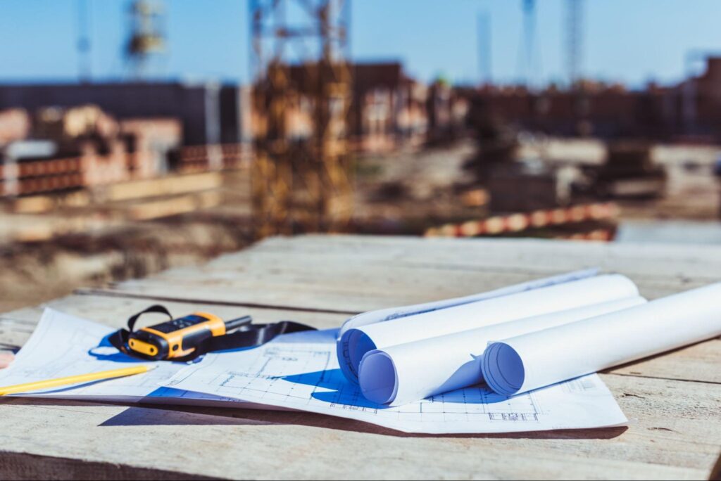 Measuring tools and construction plans on-site for successful home building.