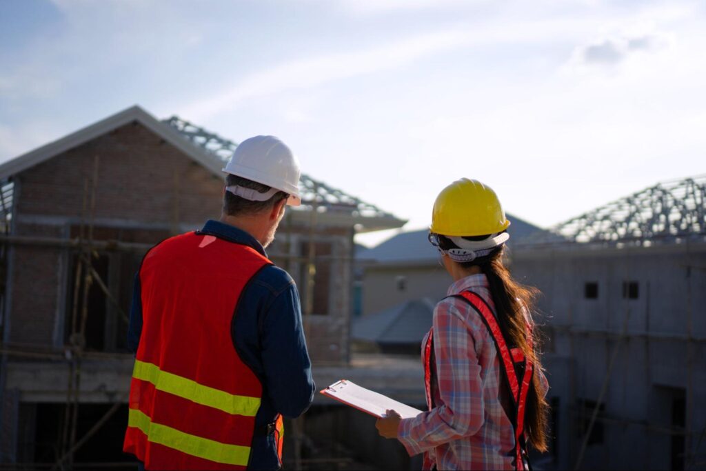Construction team evaluating progress at a new home project site.