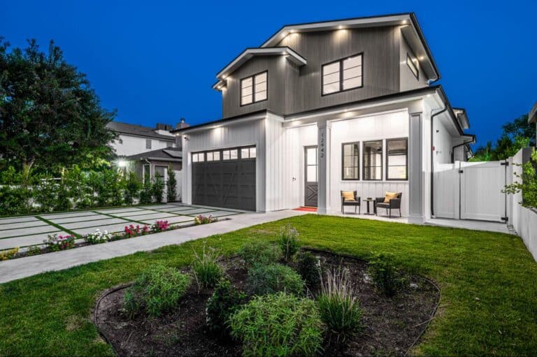 Stylish modern home with outdoor seating, landscaped yard, and inviting dusk lighting.
