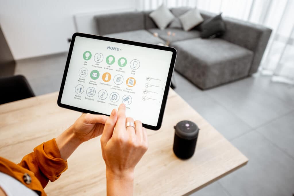 Woman using a tablet to manage smart home devices efficiently and conveniently.