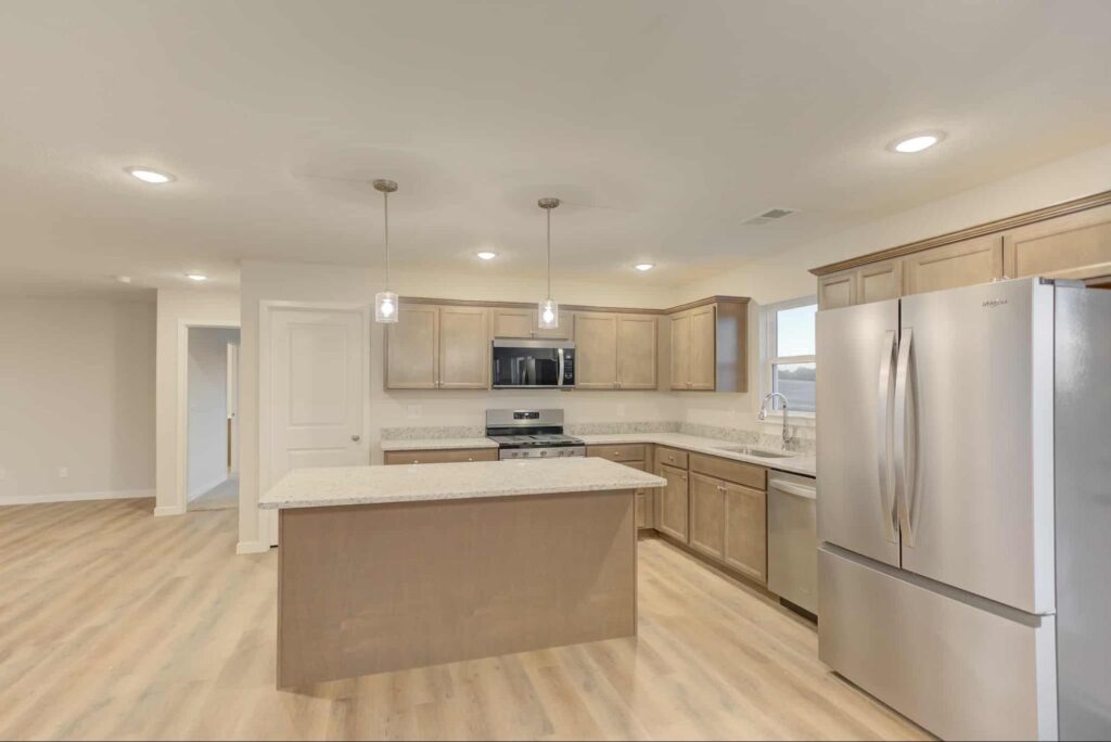 Modern kitchen with stainless steel appliances and inviting island for social gatherings.