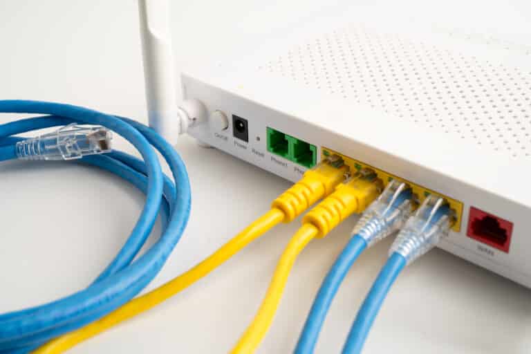 Ethernet cable connections to a wireless router for internet access.