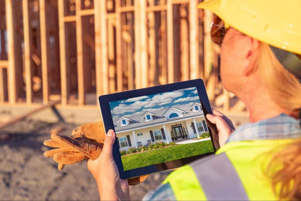 Construction worker using a tablet to visualize building designs on the job site.