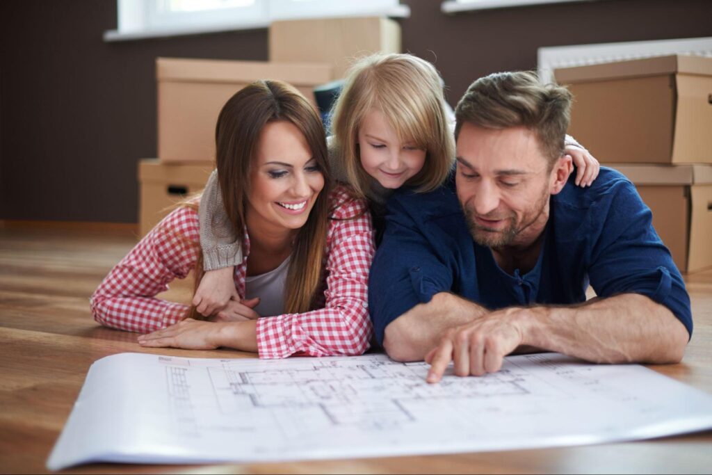 Family reviewing house plans together, dreaming of their perfect home.
